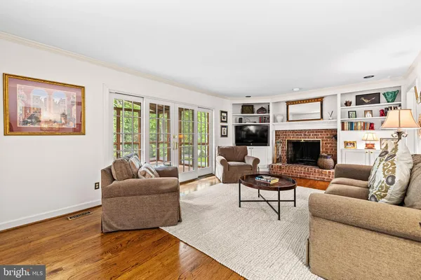 a living room with furniture fireplace and a large window