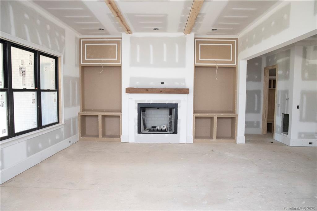 2012 Connonade Drive Waxhaw, NC 28173 - Photo 4 of 10 a view of an empty room with a fireplace and a window