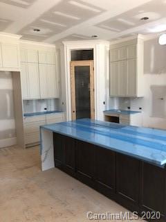 2012 Connonade Drive Waxhaw, NC 28173 - Photo 8 of 10 a kitchen with kitchen island white cabinets and refrigerator