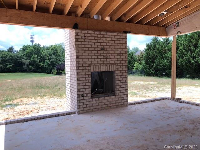2012 Connonade Drive Waxhaw, NC 28173 - Photo 9 of 10 a view of empty room with a fireplace and wooden walls