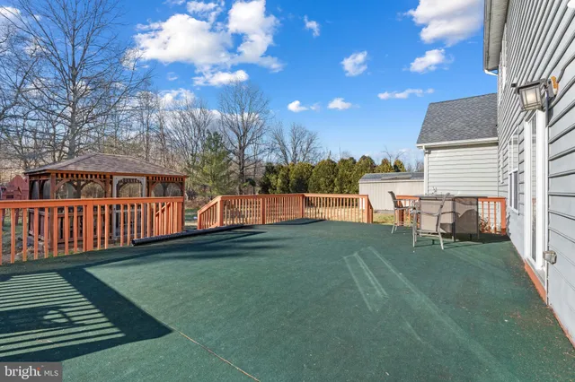 a view of a house with backyard porch and sitting area