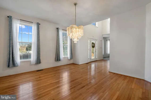a view of a kitchen with wooden floor and entryway