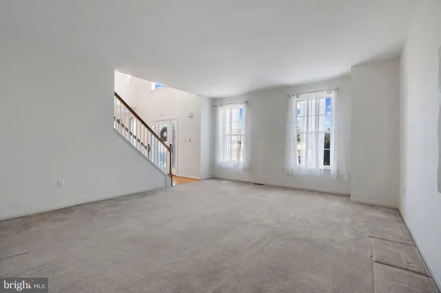 a view of an empty room with stairs