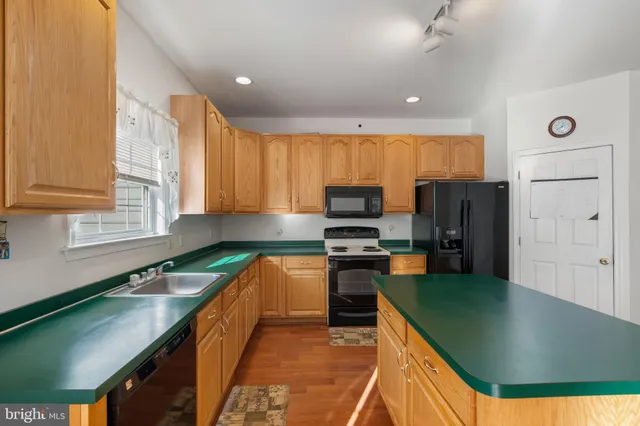 a kitchen with stainless steel appliances microwave stove refrigerator and cabinets