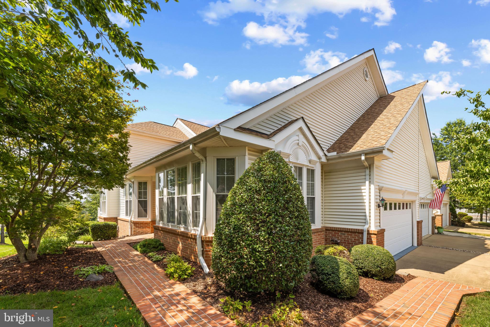 6934 Cumberstone Place Gainesville, VA 20155 - Photo 3 of 49 a front view of a house with garden