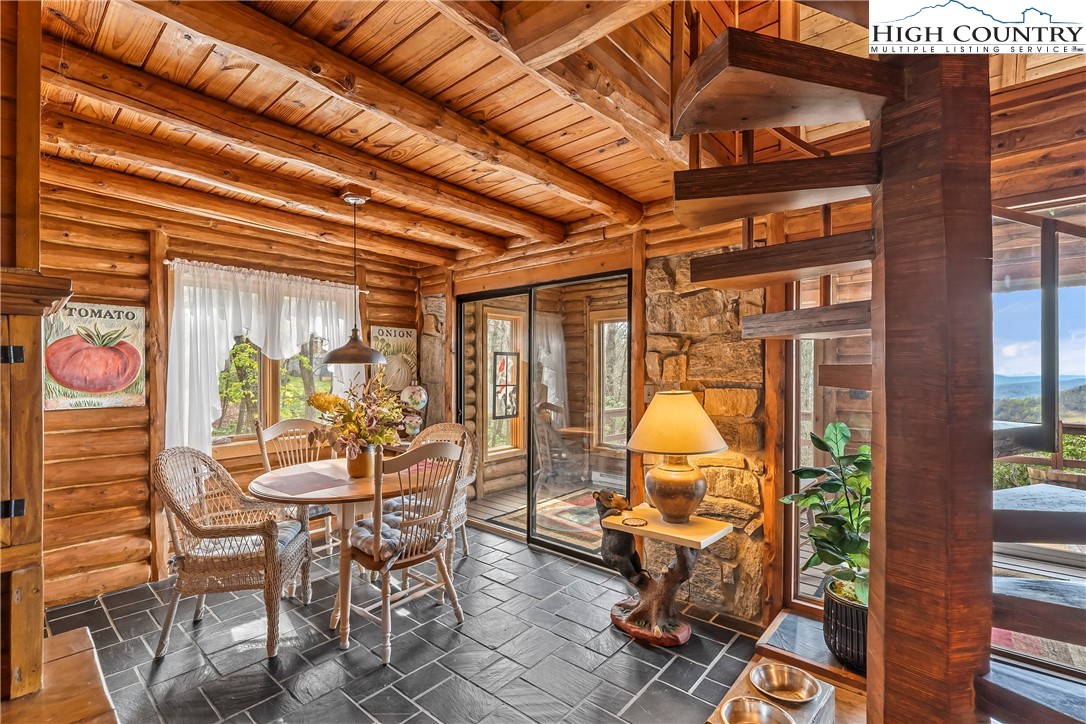 231 Deer Oaks Road Deep Gap, NC 28618 - Photo 12 of 44 a view of a patio with table and chairs and potted plants
