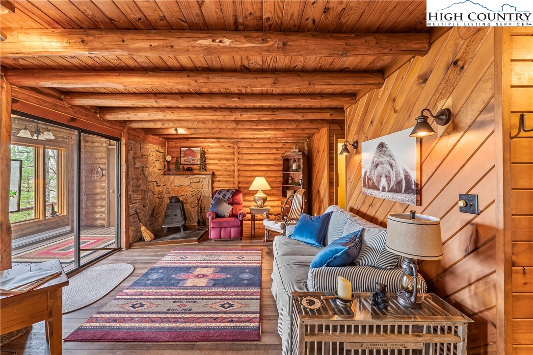 231 Deer Oaks Road Deep Gap, NC 28618 - Photo 14 of 44 a view of living room with furniture and floor to ceiling window