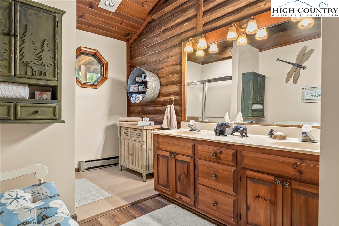 231 Deer Oaks Road Deep Gap, NC 28618 - Photo 28 of 44 a bathroom with a double vanity sink and a mirror