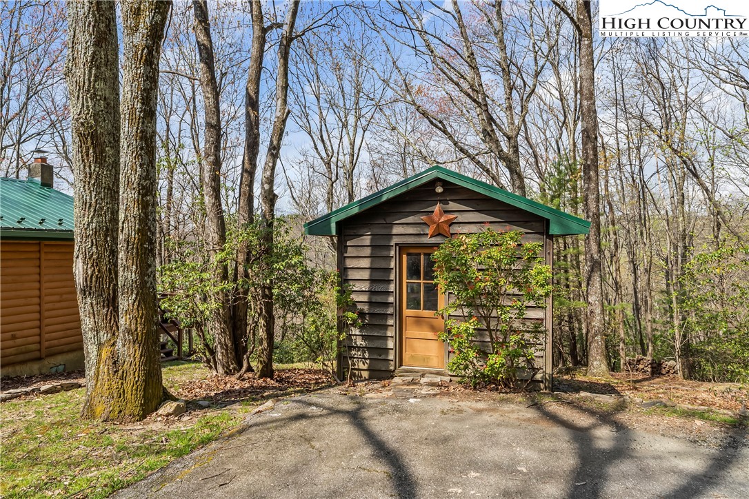 231 Deer Oaks Road Deep Gap, NC 28618 - Photo 32 of 44 a view of a house with backyard and trees