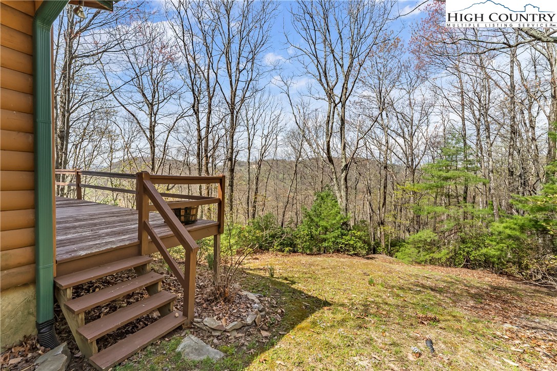 231 Deer Oaks Road Deep Gap, NC 28618 - Photo 33 of 44 a view of a bench in backyard of house