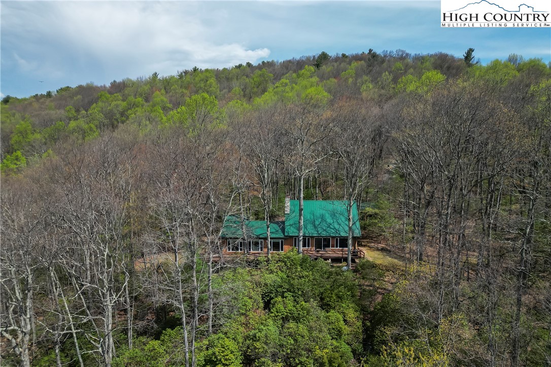 231 Deer Oaks Road Deep Gap, NC 28618 - Photo 5 of 44 a view of a bench in a garden