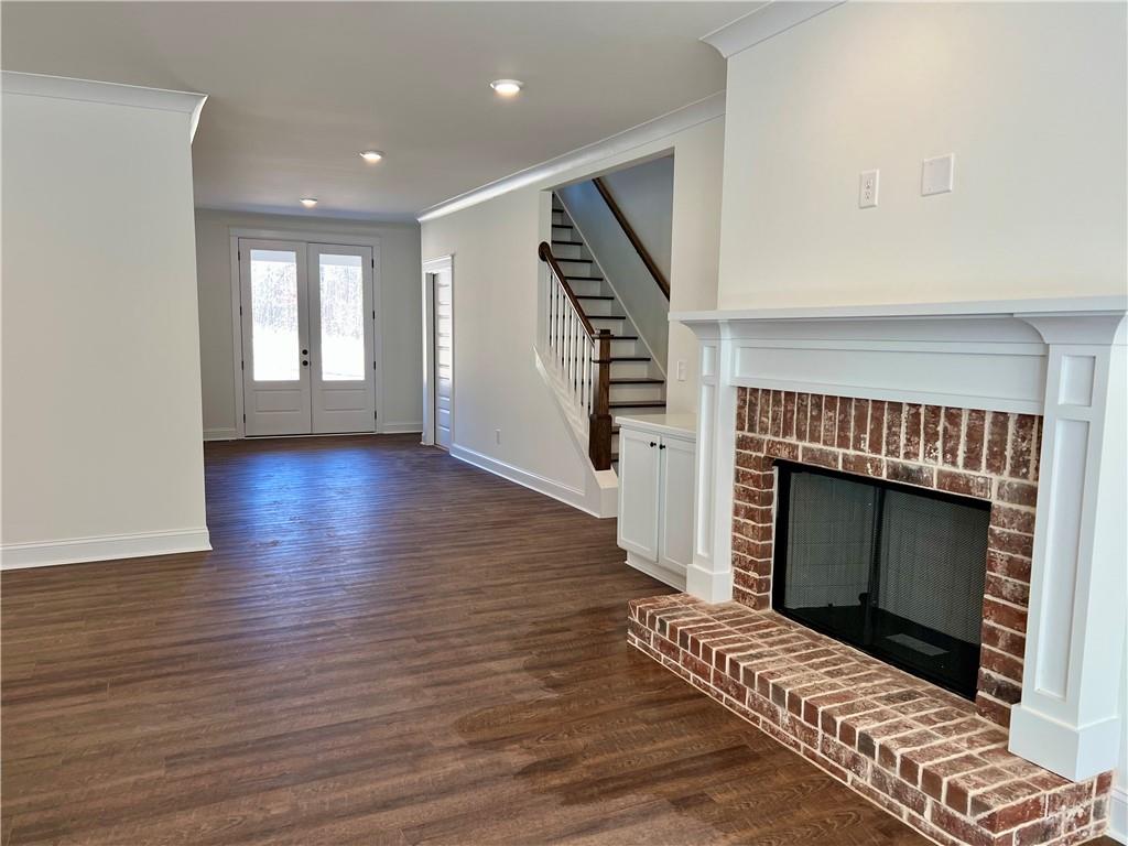 327 Primrose Lane Pendergrass, GA 30567 - Photo 11 of 41 a view of an empty room with wooden floor fireplace and a window