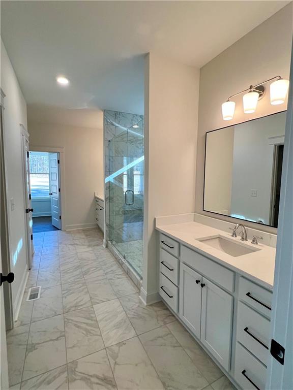327 Primrose Lane Pendergrass, GA 30567 - Photo 17 of 41 a spacious bathroom with a mirror sink and toilet