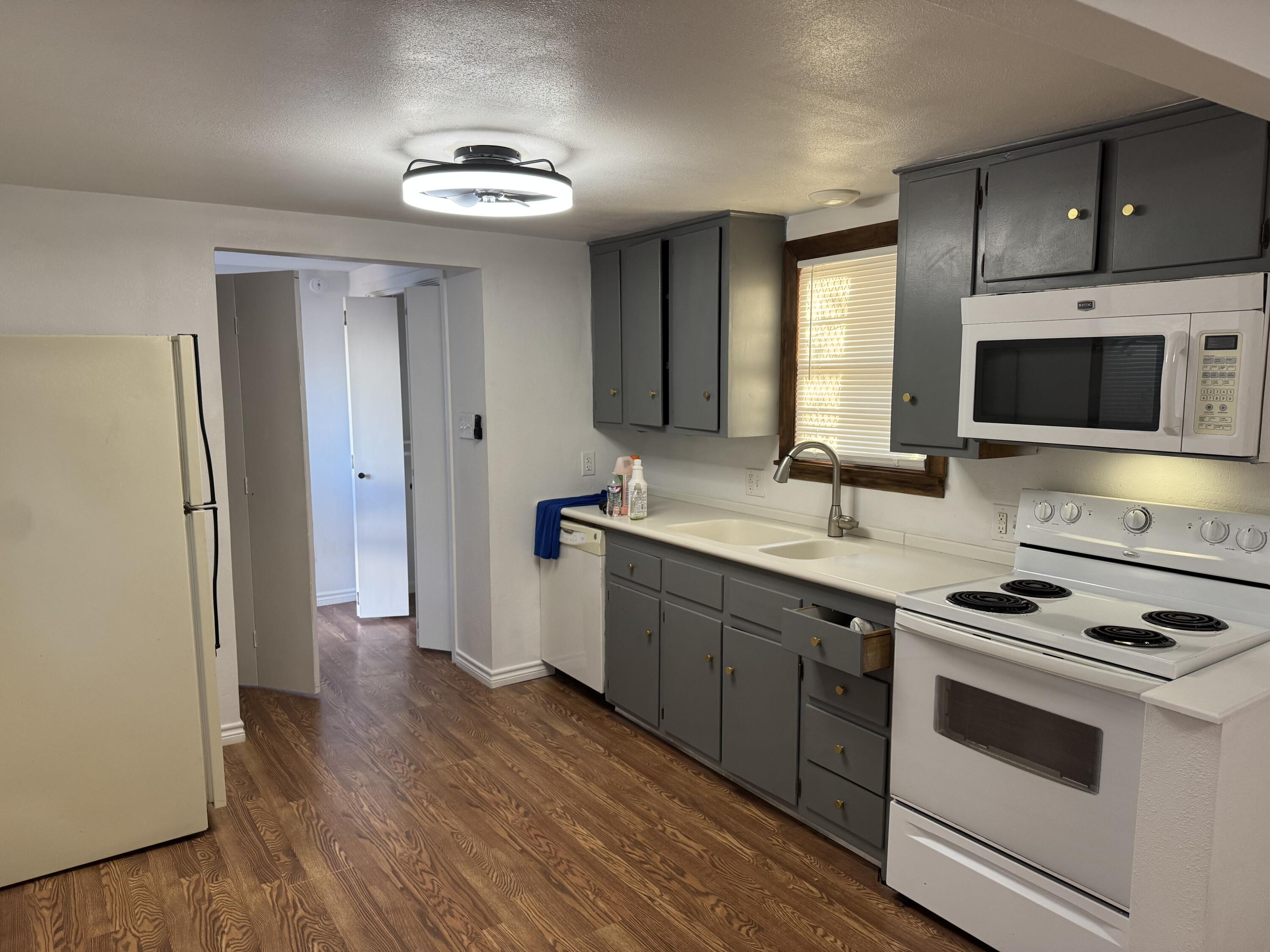 2708 20th Street, Unit REAR Lubbock, TX 79410 - Photo 1 of 10 a kitchen with a sink stove and microwave