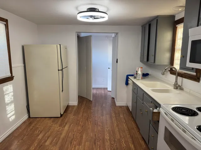 a kitchen with a sink and a refrigerator