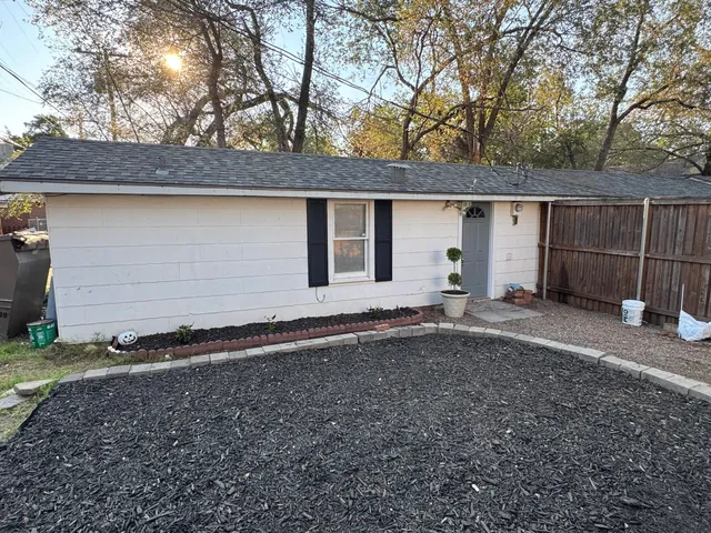 a backyard of house with a yard and garage