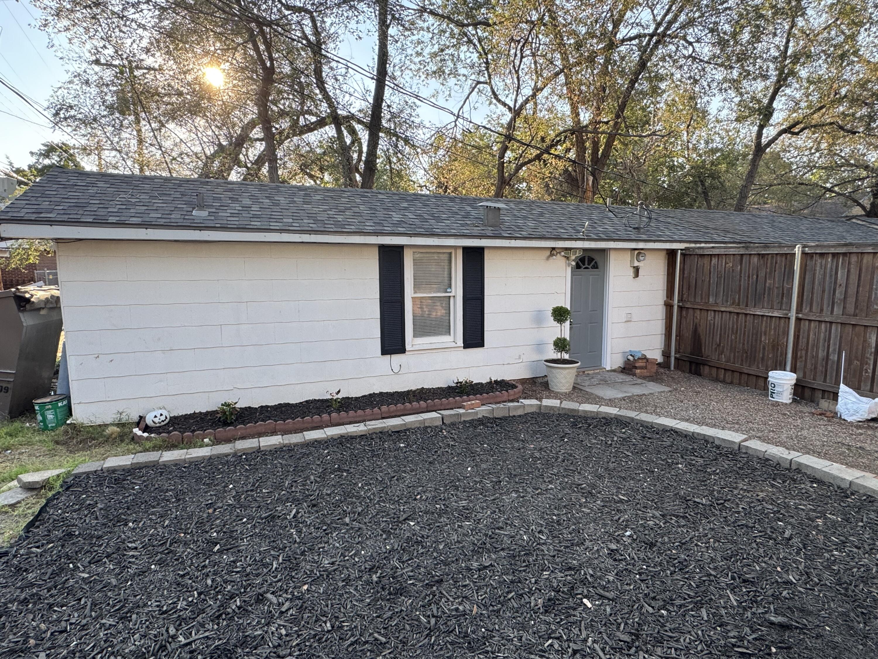 2708 20th Street, Unit REAR Lubbock, TX 79410 - Photo 9 of 10 a backyard of house with a yard and garage