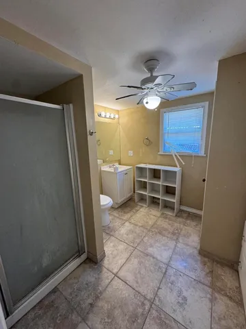 a view of a livingroom with a furniture and a ceiling fan