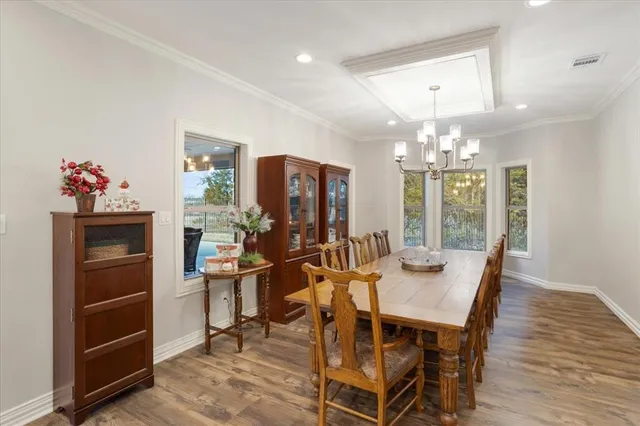 a view of a dining room with furniture and chandelier
