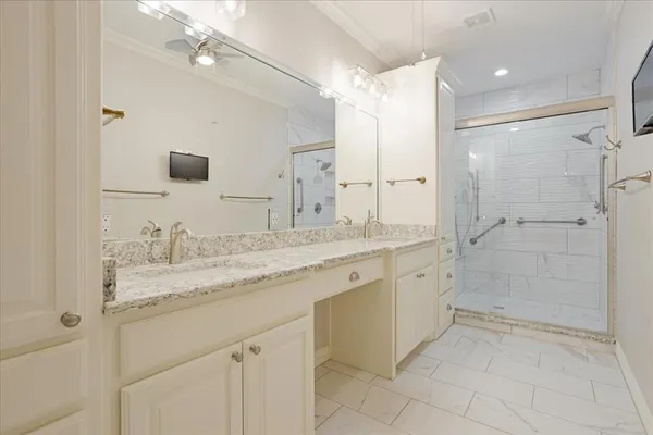 a bathroom with a granite countertop sink mirror and shower