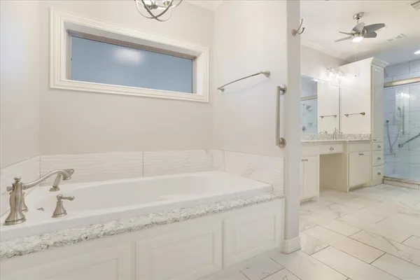 a bathroom with a granite countertop sink a toilet and bathtub