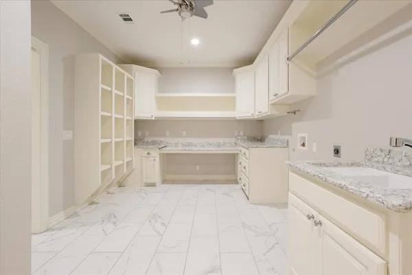 a view of a kitchen with white cabinets