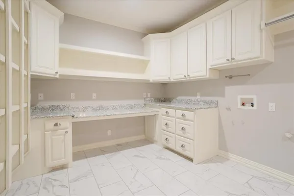 a kitchen with granite countertop white cabinets and white appliances