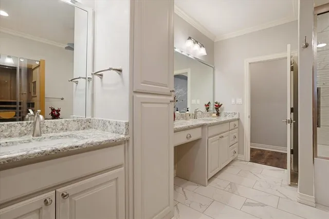 a bathroom with a granite countertop sink a mirror and a shower