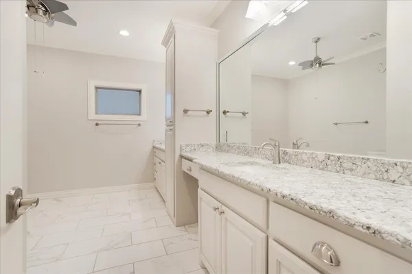 a bathroom with a granite countertop sink a mirror and shower