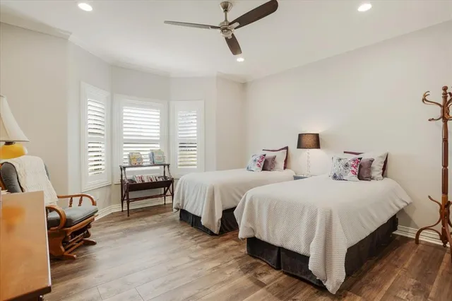 a bedroom with two beds and a chair