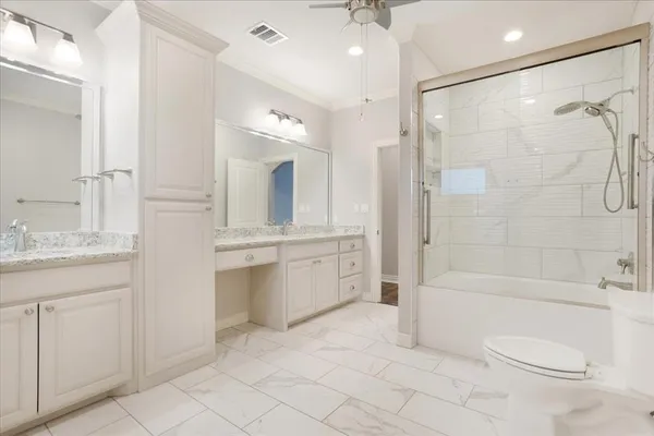 a bathroom with a bathtub shower sink and toilet