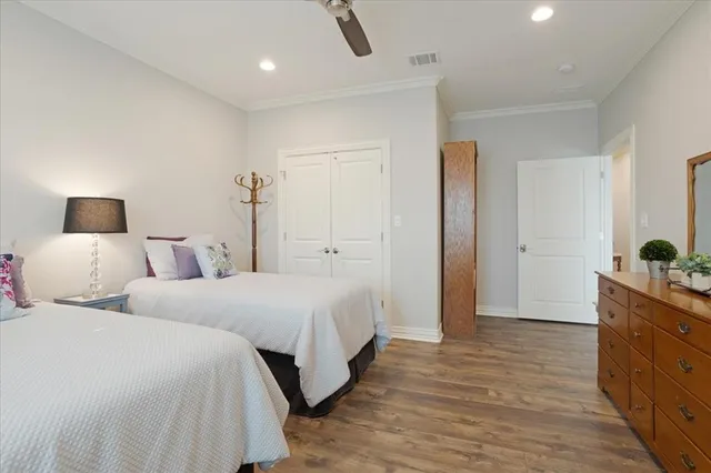 a bedroom with two bed and a closet