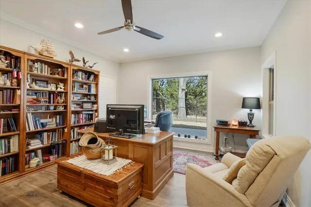 a living room with furniture and a book shelf