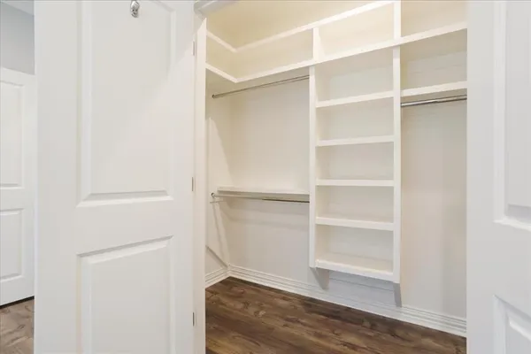 a view of walk in closet with empty racks