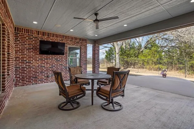 a work room with furniture and a large window