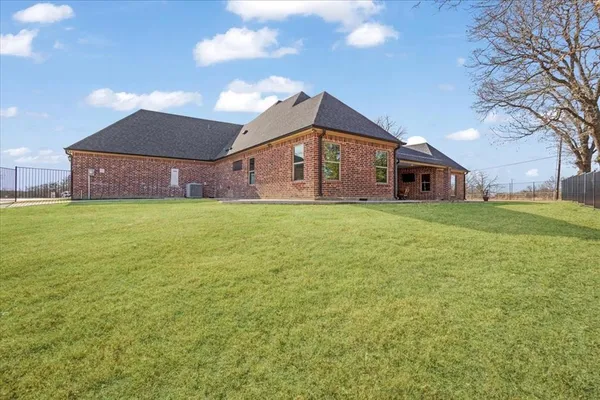 a big room with table and chairs under an umbrella
