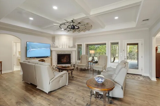 a living room with furniture a fireplace and a flat screen tv