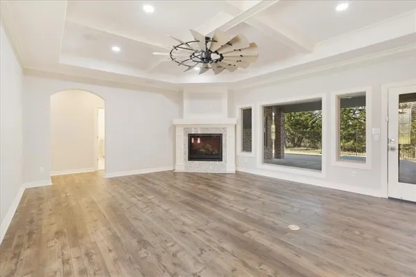 a view of an empty room with a fireplace and a window