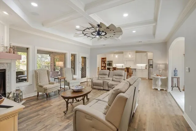 a living room with furniture or chandelier and a wooden floor