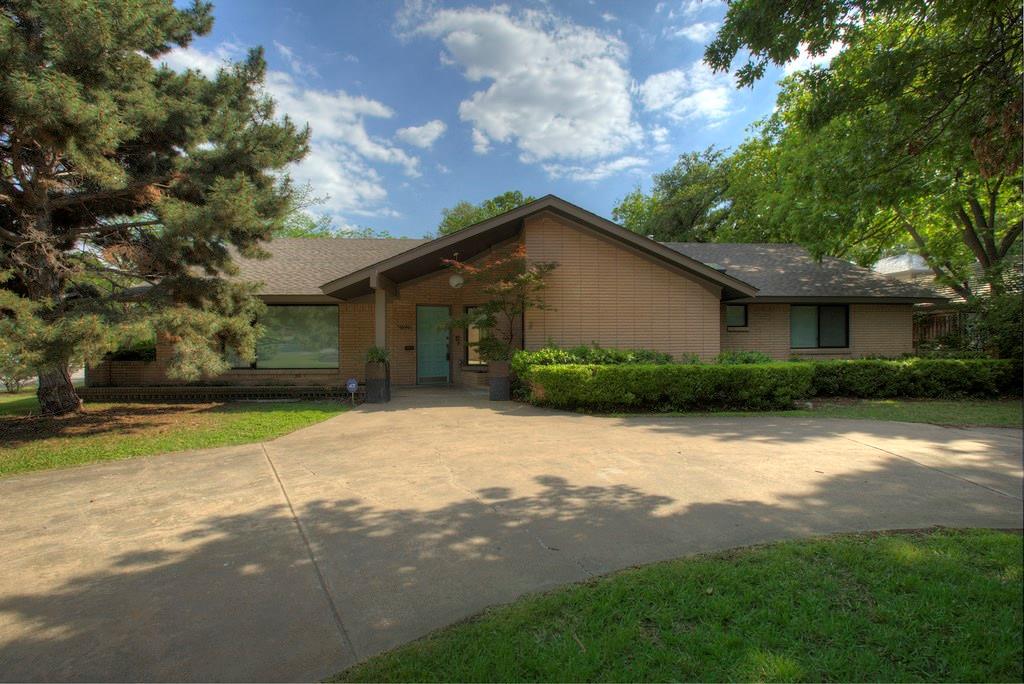 5946 Desco Drive Dallas, TX 75225 - Photo 1 of 1 a front view of house with yard and trees around