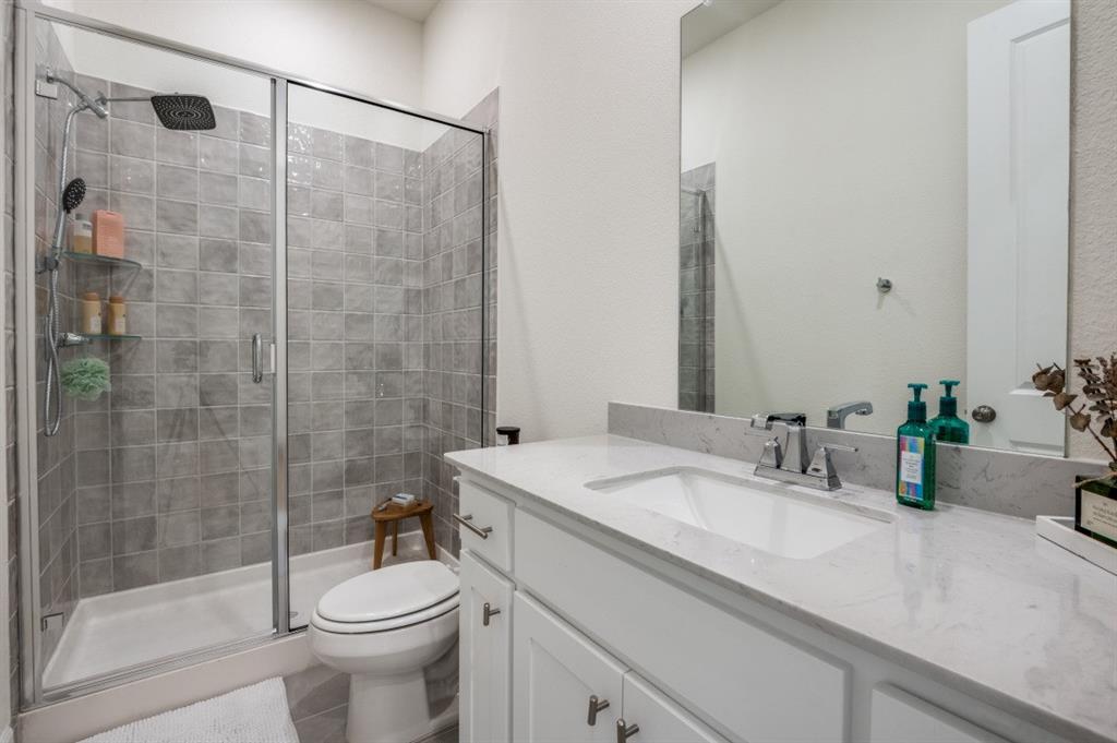 1281 Manfreda Street Prosper, TX 75078 - Photo 12 of 25 a bathroom with a sink a toilet and shower
