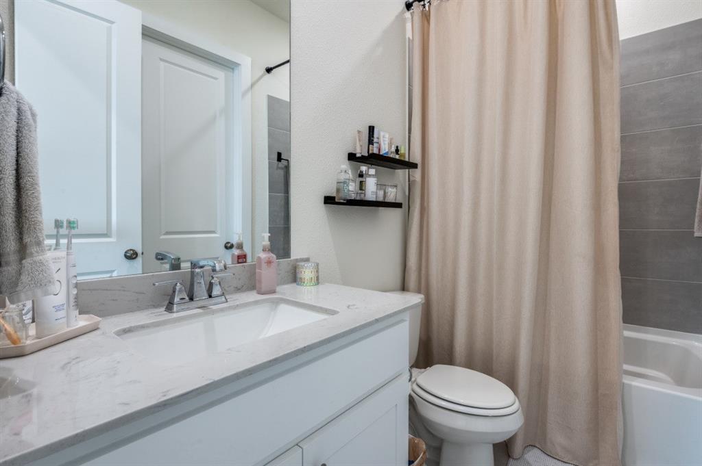 1281 Manfreda Street Prosper, TX 75078 - Photo 16 of 25 a bathroom with a sink a toilet and a mirror