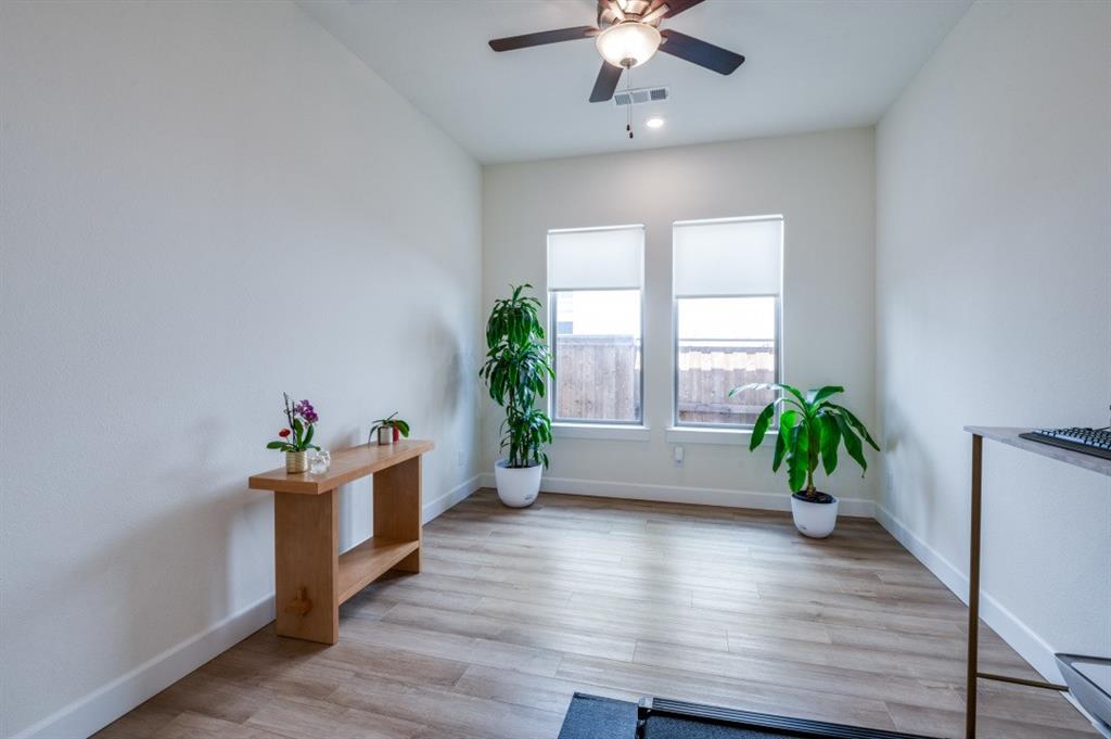 1281 Manfreda Street Prosper, TX 75078 - Photo 17 of 25 a living room with furniture and a chandelier