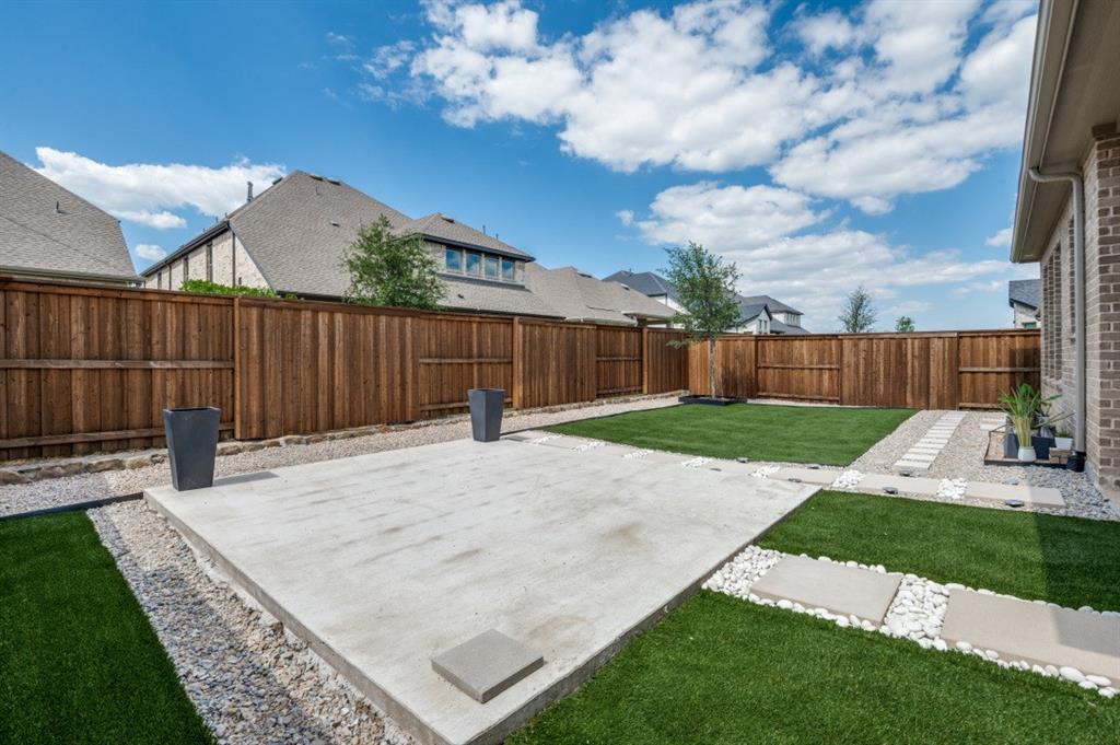 1281 Manfreda Street Prosper, TX 75078 - Photo 23 of 25 a view of a backyard with a garden