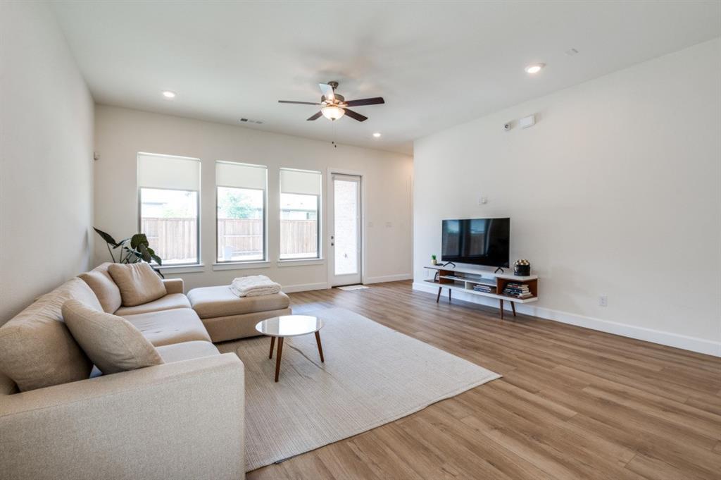 1281 Manfreda Street Prosper, TX 75078 - Photo 3 of 25 a living room with furniture and a flat screen tv