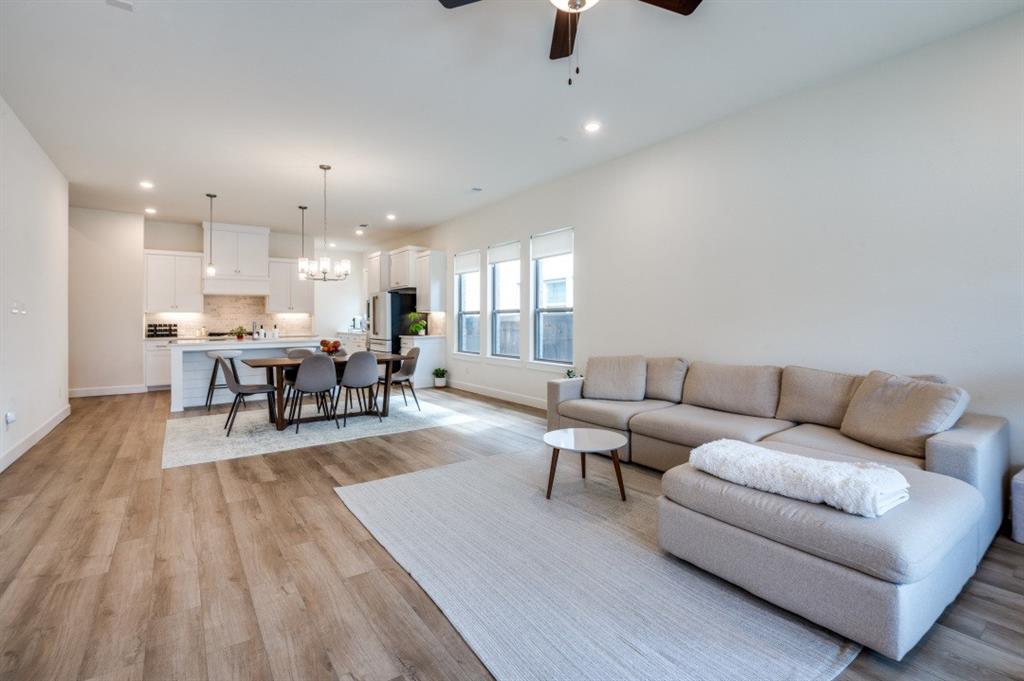 1281 Manfreda Street Prosper, TX 75078 - Photo 4 of 25 a living room with furniture and kitchen view