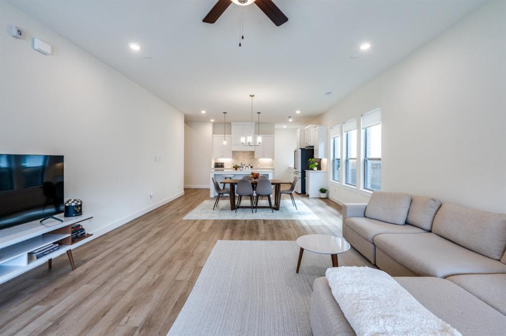 1281 Manfreda Street Prosper, TX 75078 - Photo 5 of 25 a living room with furniture and a flat screen tv