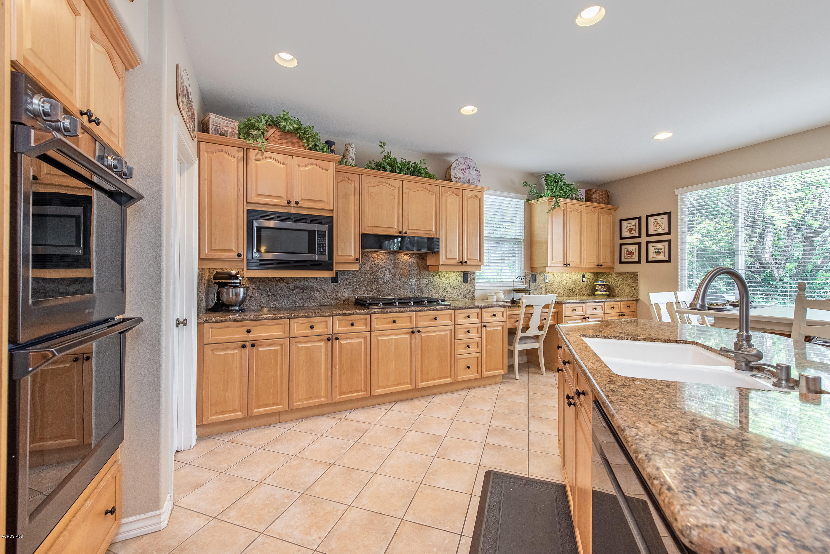 13625 Silver Oak Lane Moorpark, CA 93021 - Photo 12 of 35 a large kitchen with granite countertop a large stove a sink and a microwave