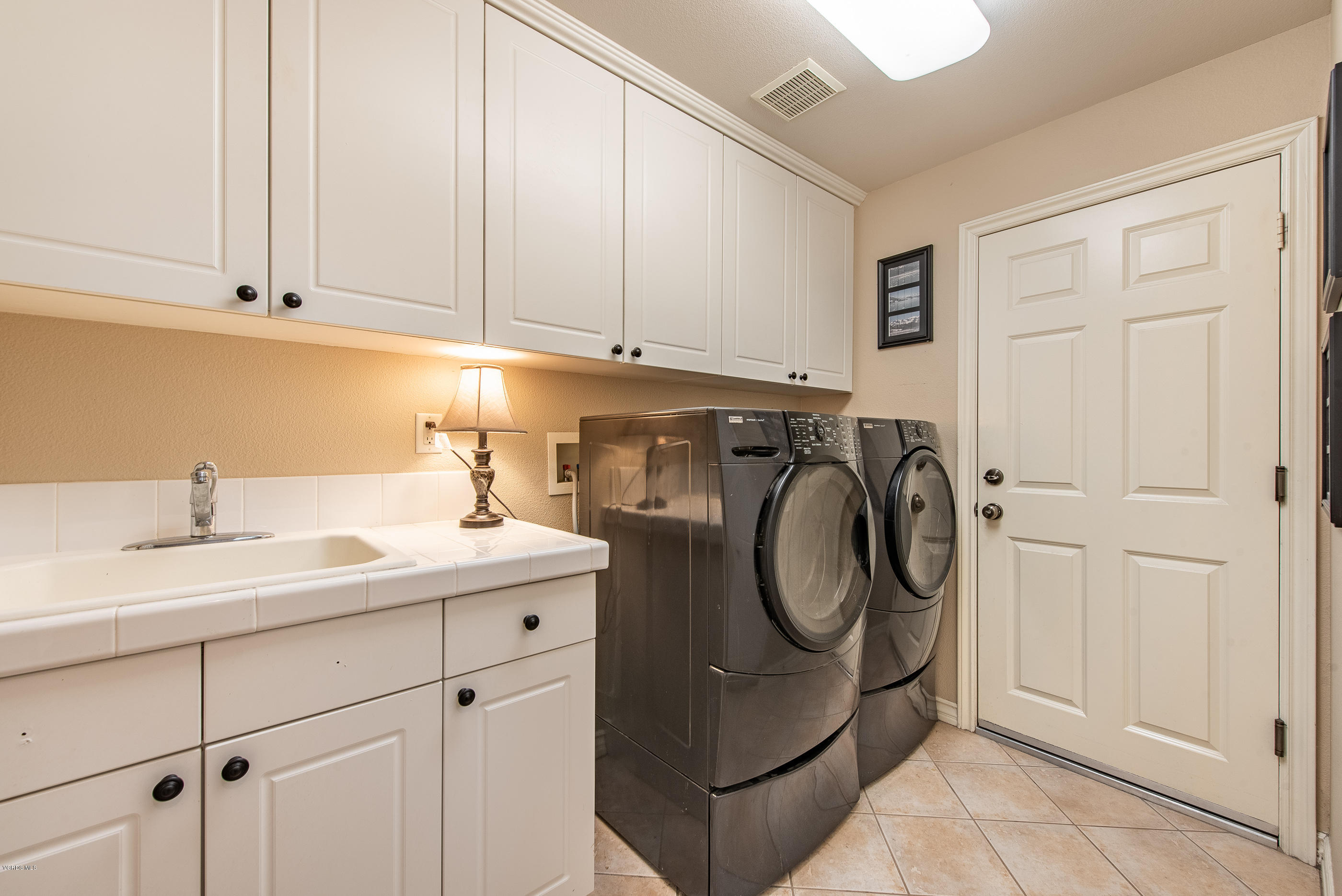 13625 Silver Oak Lane Moorpark, CA 93021 - Photo 19 of 35 a utility room with sink dryer and washer