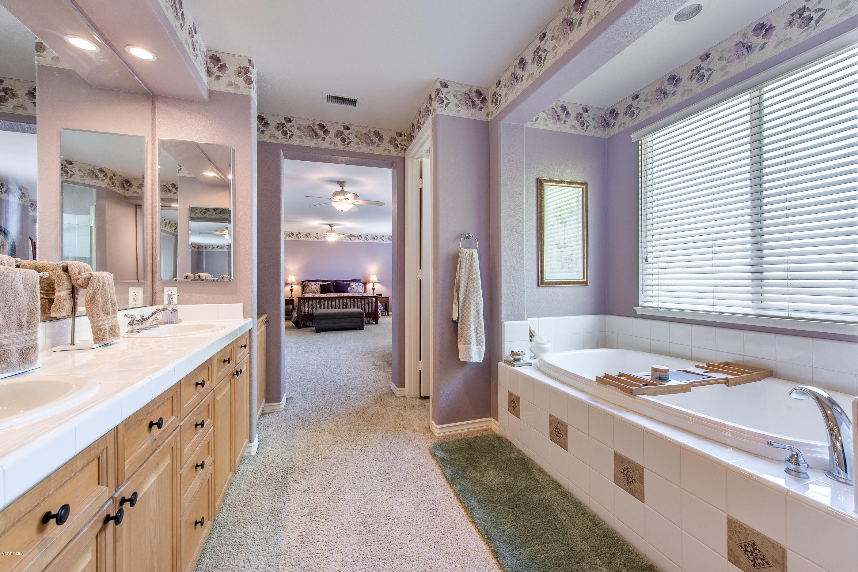 13625 Silver Oak Lane Moorpark, CA 93021 - Photo 24 of 35 a bathroom with a granite countertop sink and a large mirror